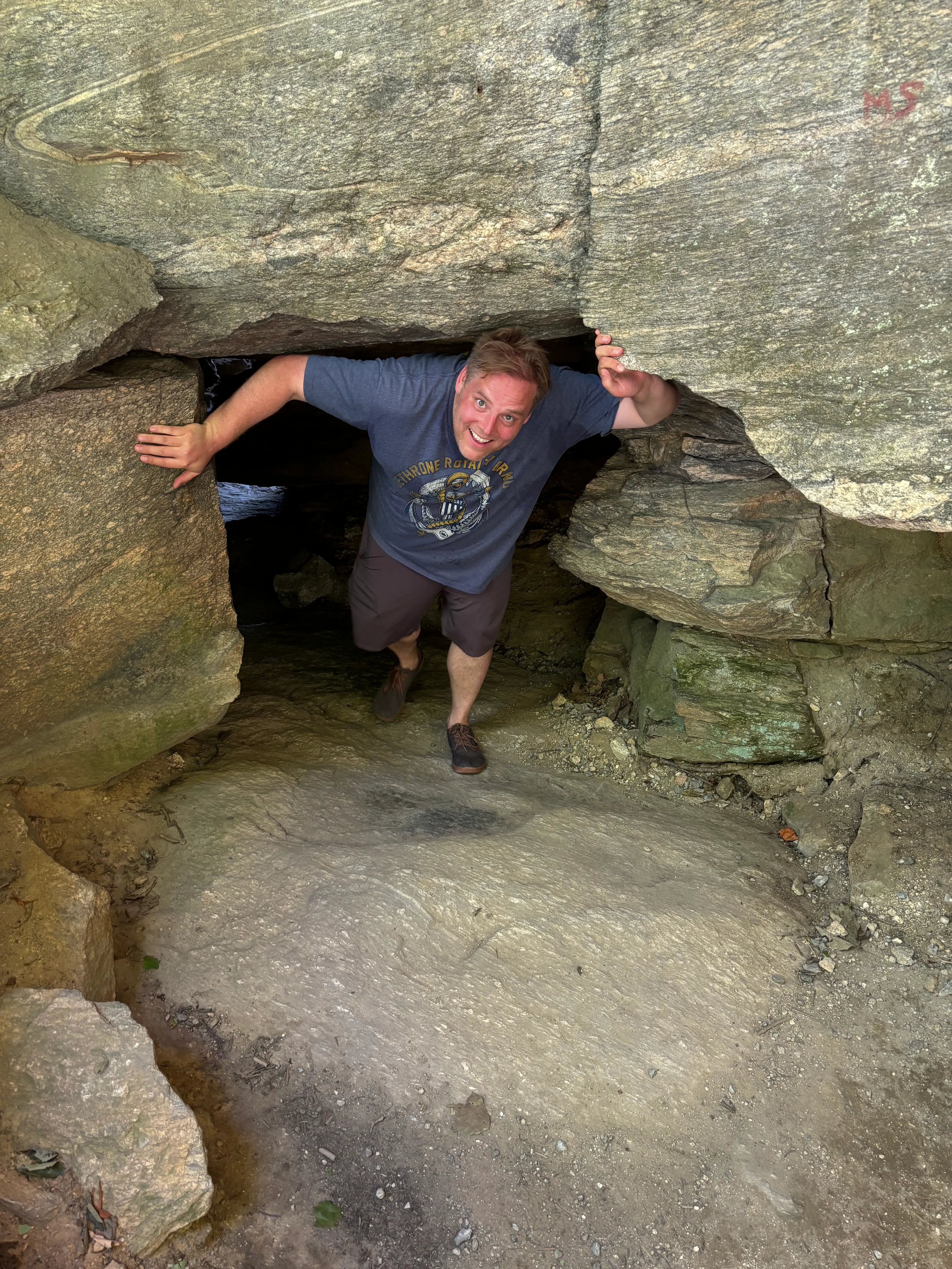 image of gavin walking through cave