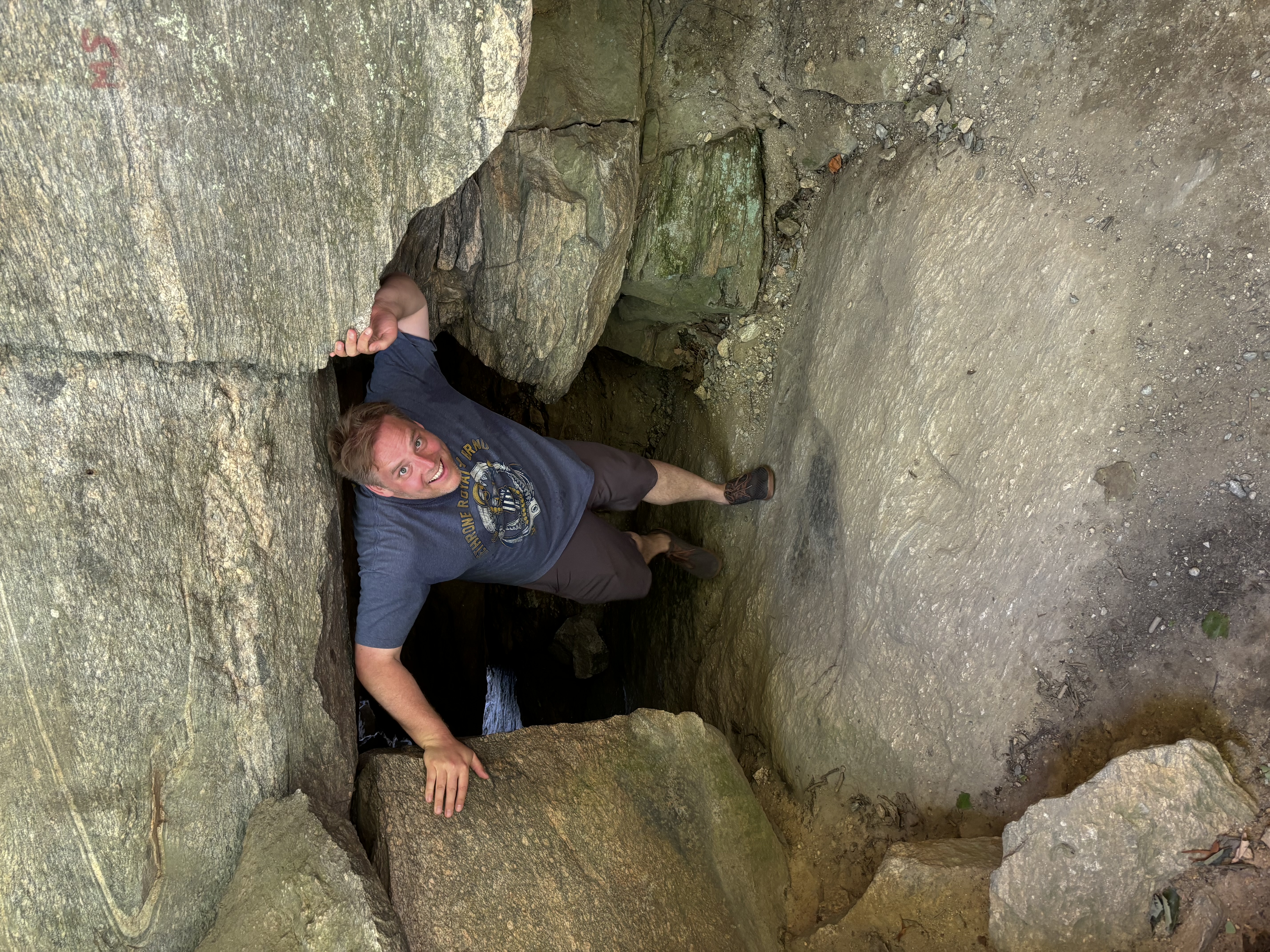 image of gavin walking through cave